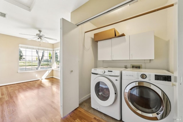 washroom featuring washing machine and clothes dryer, light wood finished floors, baseboards, ceiling fan, and laundry area
