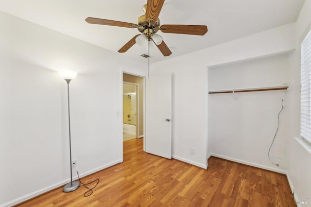 unfurnished bedroom featuring baseboards, light wood finished floors, visible vents, a ceiling fan, and a closet