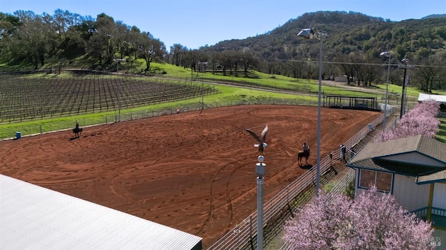 surrounding community with a mountain view, a rural view, and an enclosed area