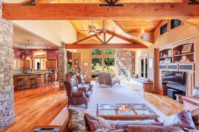 living room with high vaulted ceiling, beam ceiling, and ceiling fan