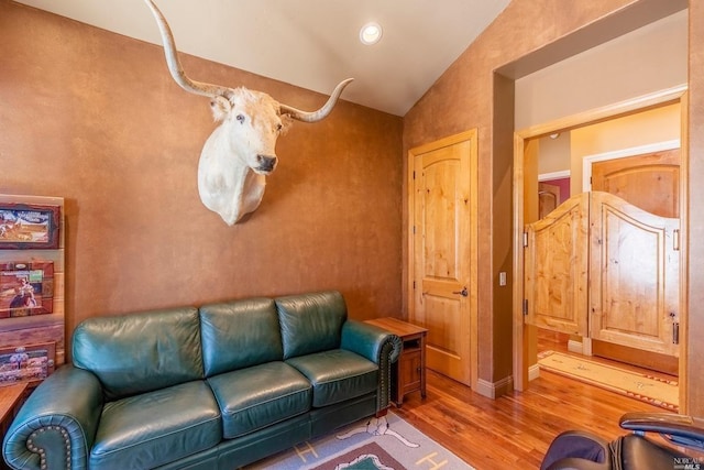 living area featuring wood finished floors, vaulted ceiling, and recessed lighting