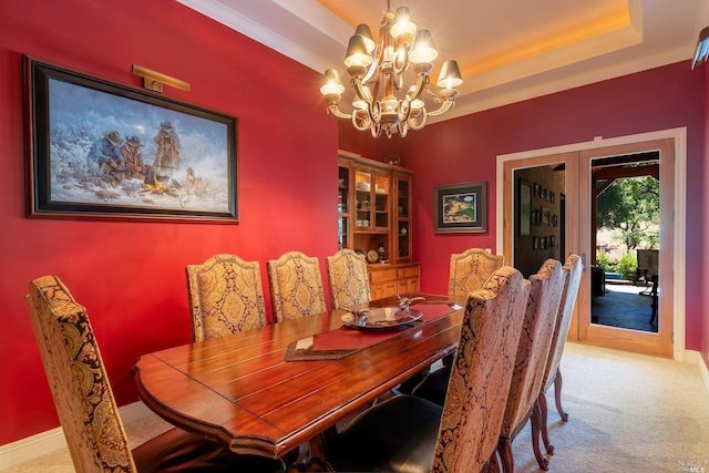 dining room featuring french doors, baseboards, carpet, and an inviting chandelier