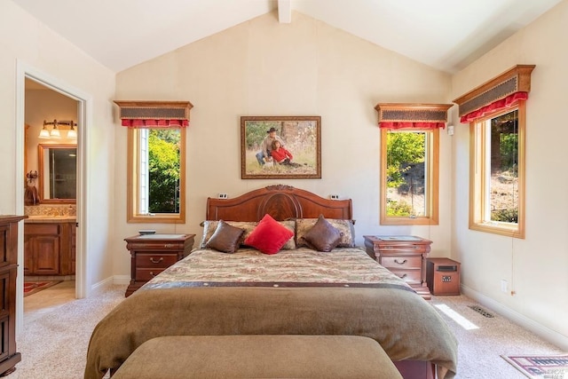 bedroom featuring connected bathroom, light carpet, vaulted ceiling with beams, and visible vents