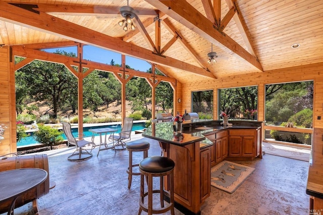 view of patio / terrace featuring outdoor wet bar, an outdoor kitchen, and an outdoor pool