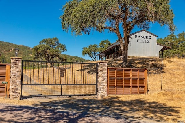 exterior space with a gate and stone siding