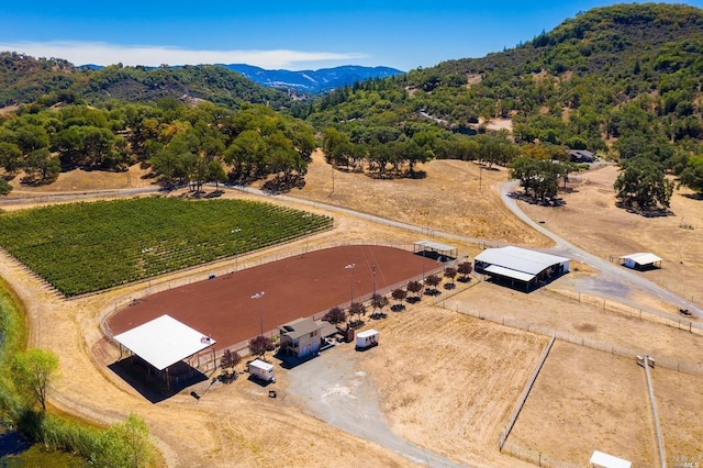birds eye view of property featuring a mountain view and a rural view