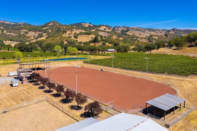 exterior space featuring an enclosed area, a mountain view, and a rural view