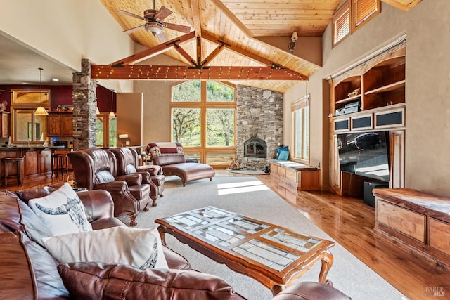 living room featuring decorative columns, high vaulted ceiling, wood ceiling, a ceiling fan, and wood finished floors