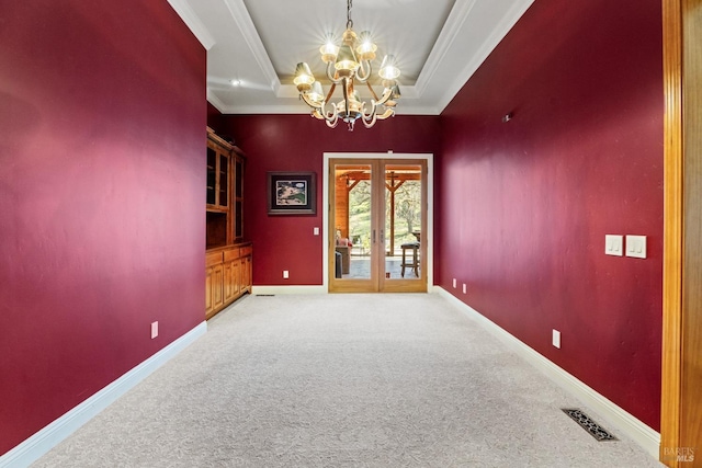 empty room featuring visible vents, crown molding, french doors, and an inviting chandelier