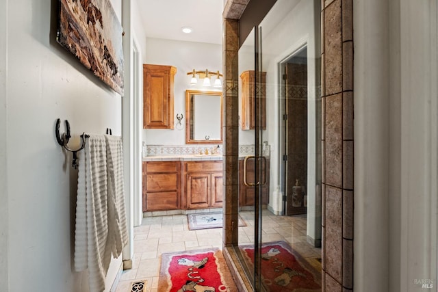 full bath with a shower stall, visible vents, stone finish flooring, and vanity