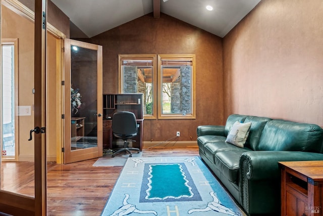 office space with baseboards, vaulted ceiling with beams, wood finished floors, and french doors