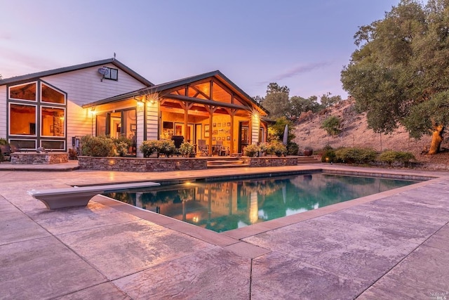pool featuring a patio and a diving board