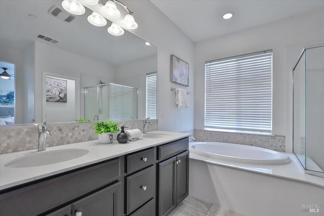 full bathroom featuring a sink, a stall shower, and visible vents