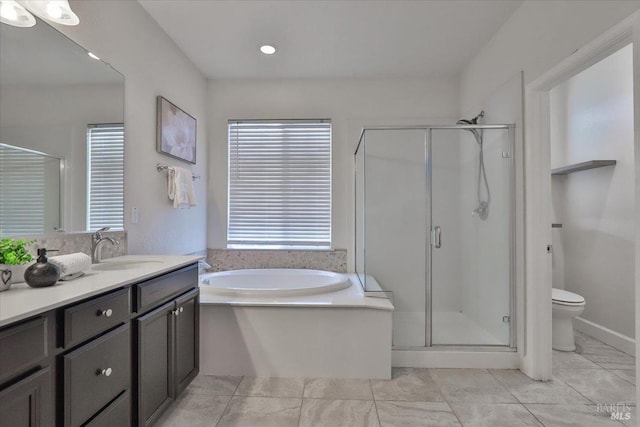 bathroom featuring vanity, toilet, a shower stall, tile patterned floors, and a bath