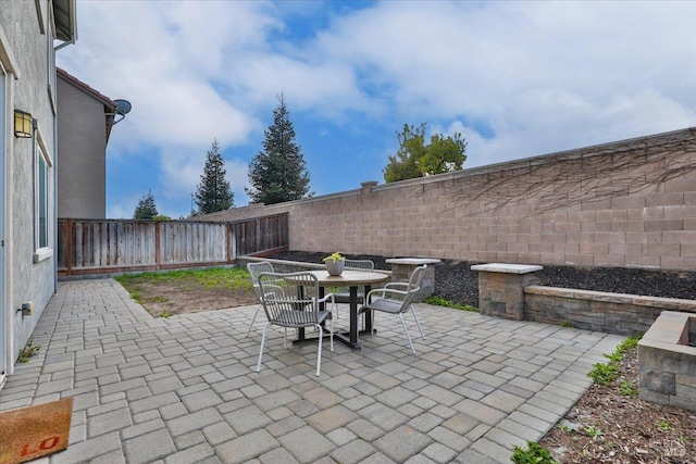 view of patio featuring a fenced backyard and outdoor dining space