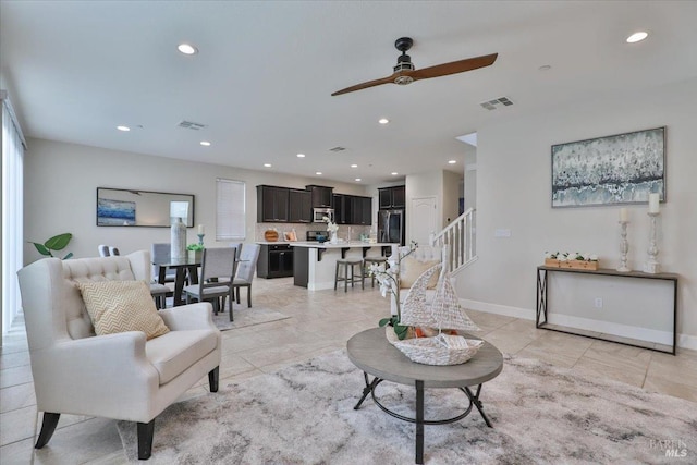 living area with visible vents, recessed lighting, and a ceiling fan