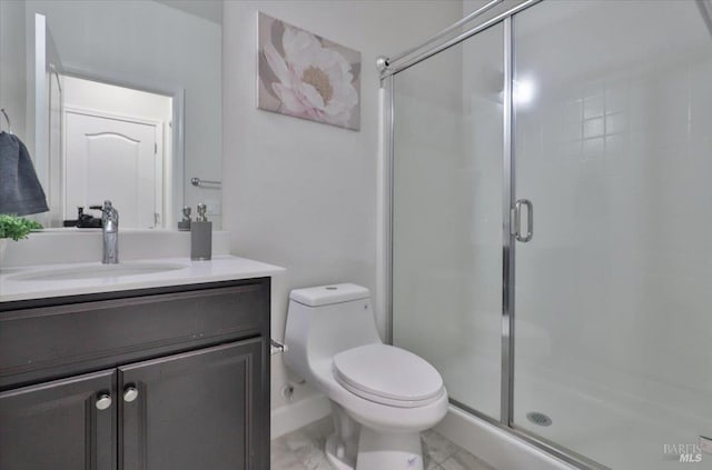 full bath with a stall shower, toilet, and vanity