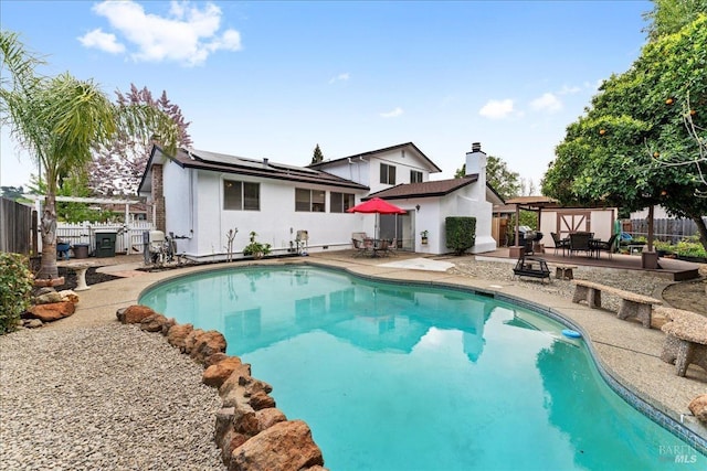 view of pool with a fenced backyard, a fenced in pool, a patio, and outdoor dining area