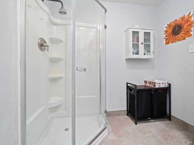 bathroom featuring baseboards and a shower stall