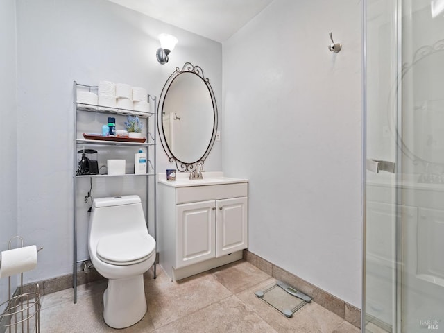 bathroom featuring toilet, vanity, baseboards, and walk in shower