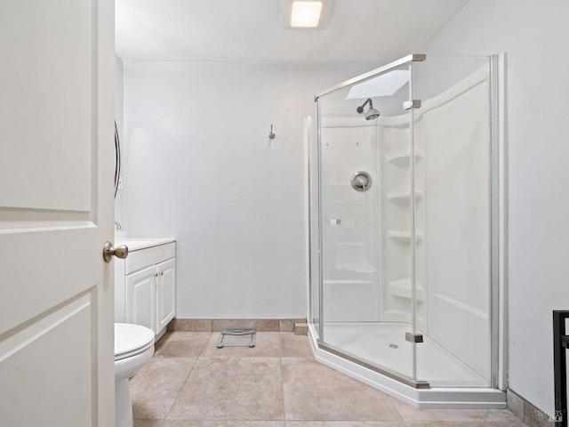 full bath with a shower stall, vanity, baseboards, and toilet