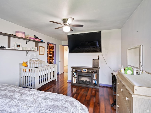 bedroom with wood finished floors and baseboards