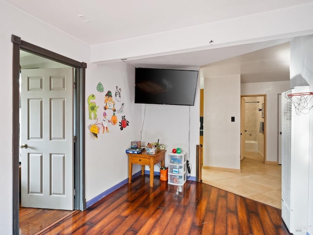 interior space with wood finished floors and baseboards