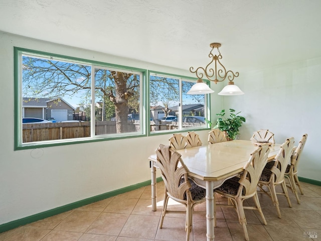 dining area with light tile patterned floors and baseboards