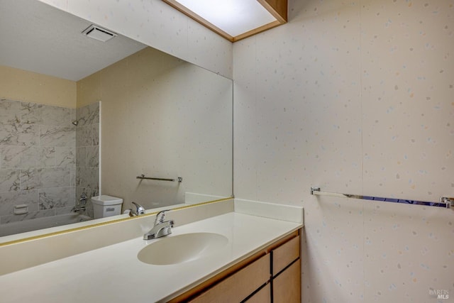 bathroom featuring shower / tub combination, visible vents, toilet, and vanity
