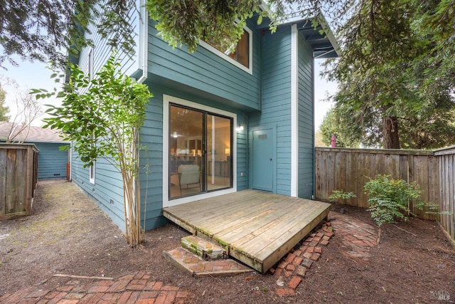 back of property with a fenced backyard and a wooden deck