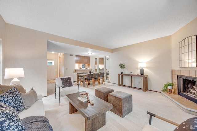 carpeted living area featuring a fireplace