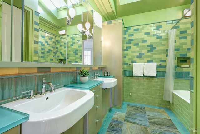full bath with tile walls, a notable chandelier, a relaxing tiled tub, tiled shower, and a skylight