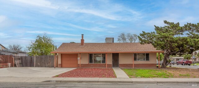 900 5th St, Fairfield, CA 94533 - view of front of property featuring driveway, an attached garage, brick siding, and a chimney