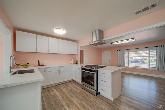 900 5th St, Fairfield, CA 94533 - kitchen with visible vents, a sink, a peninsula, gas stove, and island range hood
