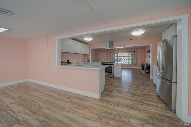 900 5th St, Fairfield, CA 94533 - kitchen with range hood, visible vents, light countertops, appliances with stainless steel finishes, and a peninsula
