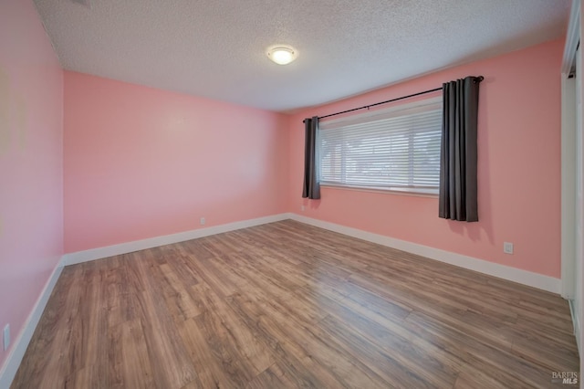 900 5th St, Fairfield, CA 94533 - spare room featuring a textured ceiling, baseboards, and wood finished floors