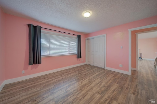 900 5th St, Fairfield, CA 94533 - unfurnished bedroom featuring a closet, a textured ceiling, baseboards, and wood finished floors