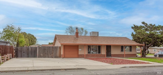 900 5th St, Fairfield, CA 94533 - ranch-style home with concrete driveway, an attached garage, a chimney, and brick siding