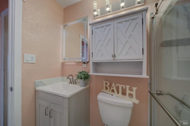 900 5th St, Fairfield, CA 94533 - bathroom with vanity, toilet, a textured wall, and a shower with door