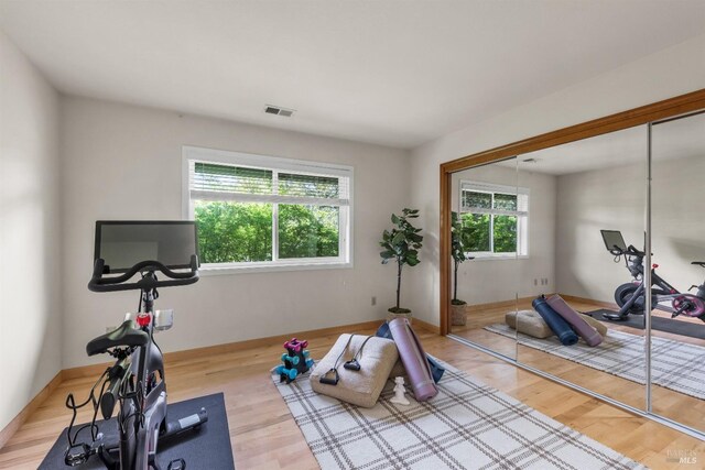 exercise room featuring visible vents and wood finished floors