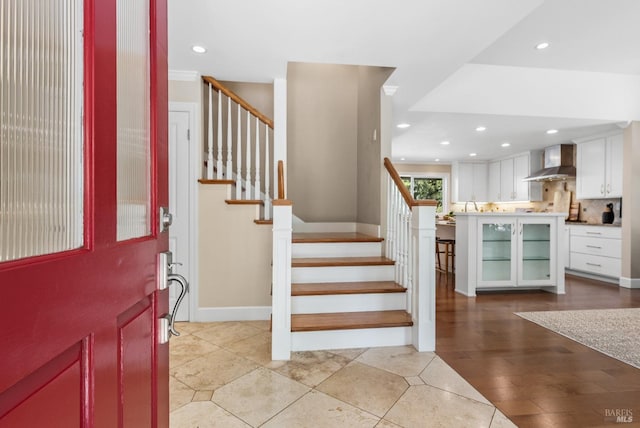 entryway featuring light tile patterned flooring, baseboards, stairs, and recessed lighting