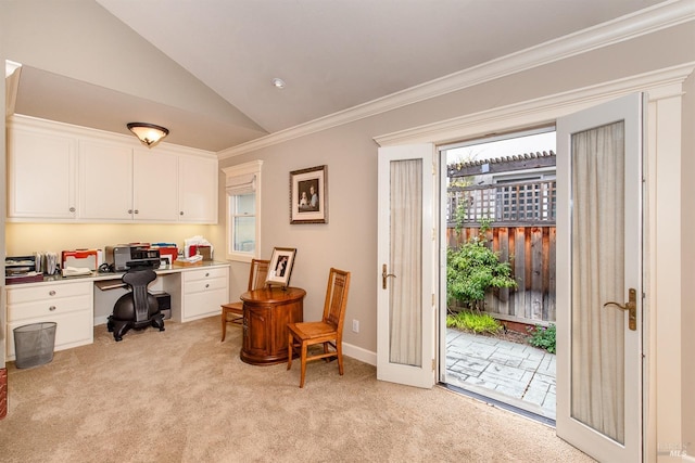 office space featuring baseboards, ornamental molding, lofted ceiling, built in study area, and light colored carpet