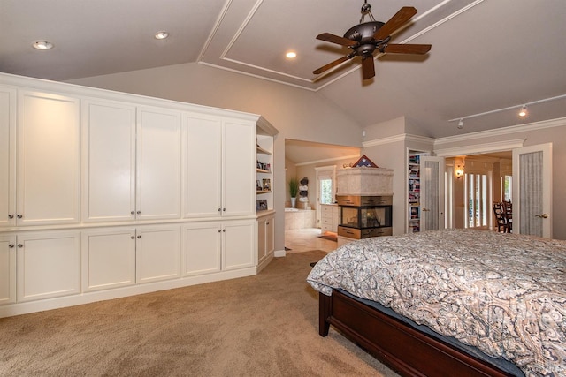 bedroom with light colored carpet and lofted ceiling