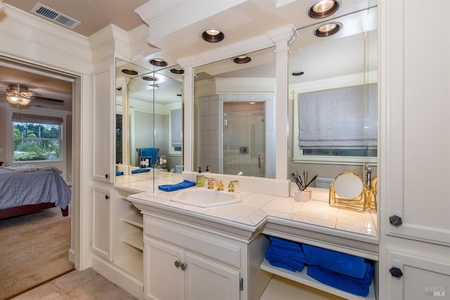 full bathroom featuring visible vents, crown molding, a shower stall, tile patterned floors, and vanity