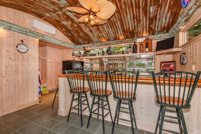 bar with a wall mounted AC, wood ceiling, a dry bar, wooden walls, and ceiling fan