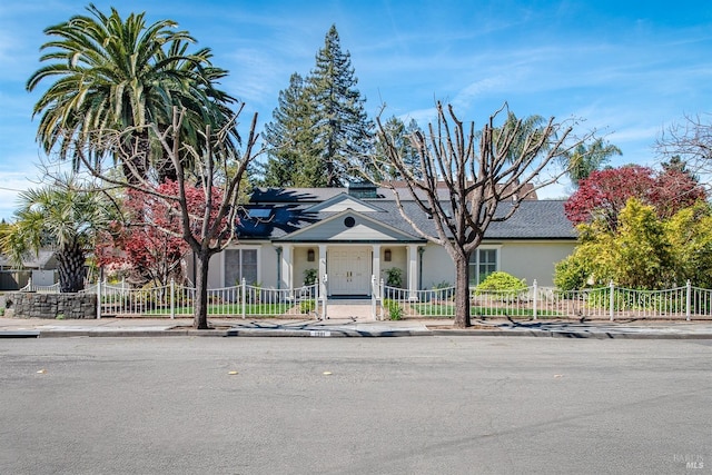 view of front of home with stucco siding and a fenced front yard