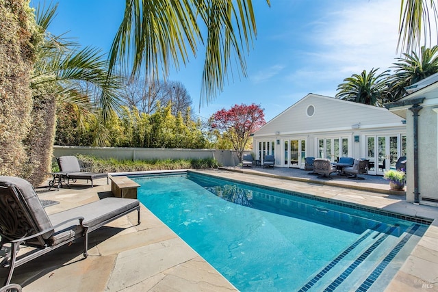 view of pool with a storage structure, a patio area, and french doors