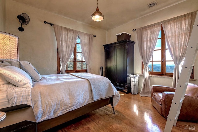 bedroom with visible vents and light wood-style flooring