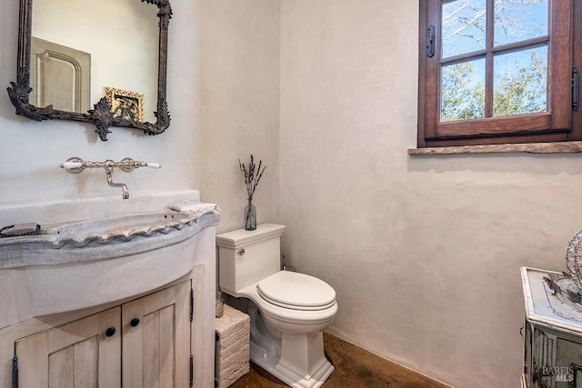 bathroom featuring toilet and vanity
