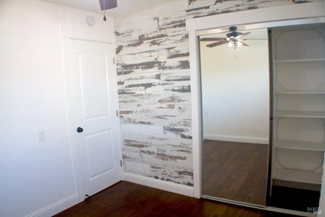 224 Walnut St, Suisun City, CA 94585 - interior space with baseboards, a closet, an accent wall, and dark wood-type flooring